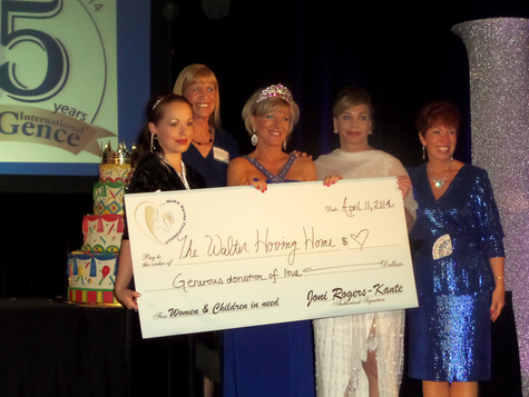 Jeri Taylor-Swade along with Joni Rogers-Kante, CEO of SeneGence presenting a donation on stage to the Walter Hoving Home of Las Vegas